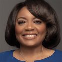 African american woman smiling in a blue outfit